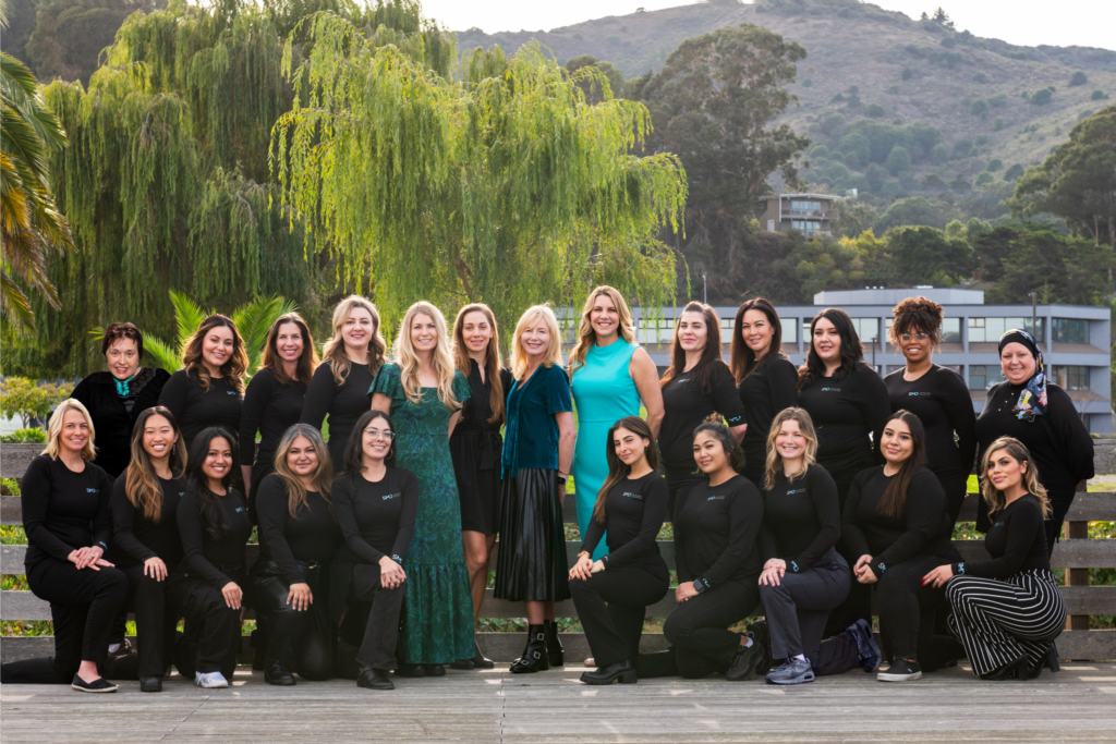 Photo of full SMD staff consisting of our board certified dermatologists, physician assistants, medical assistants, esthetician, and patient coordinators in front of our dermatology practice located in Sausalito, CA